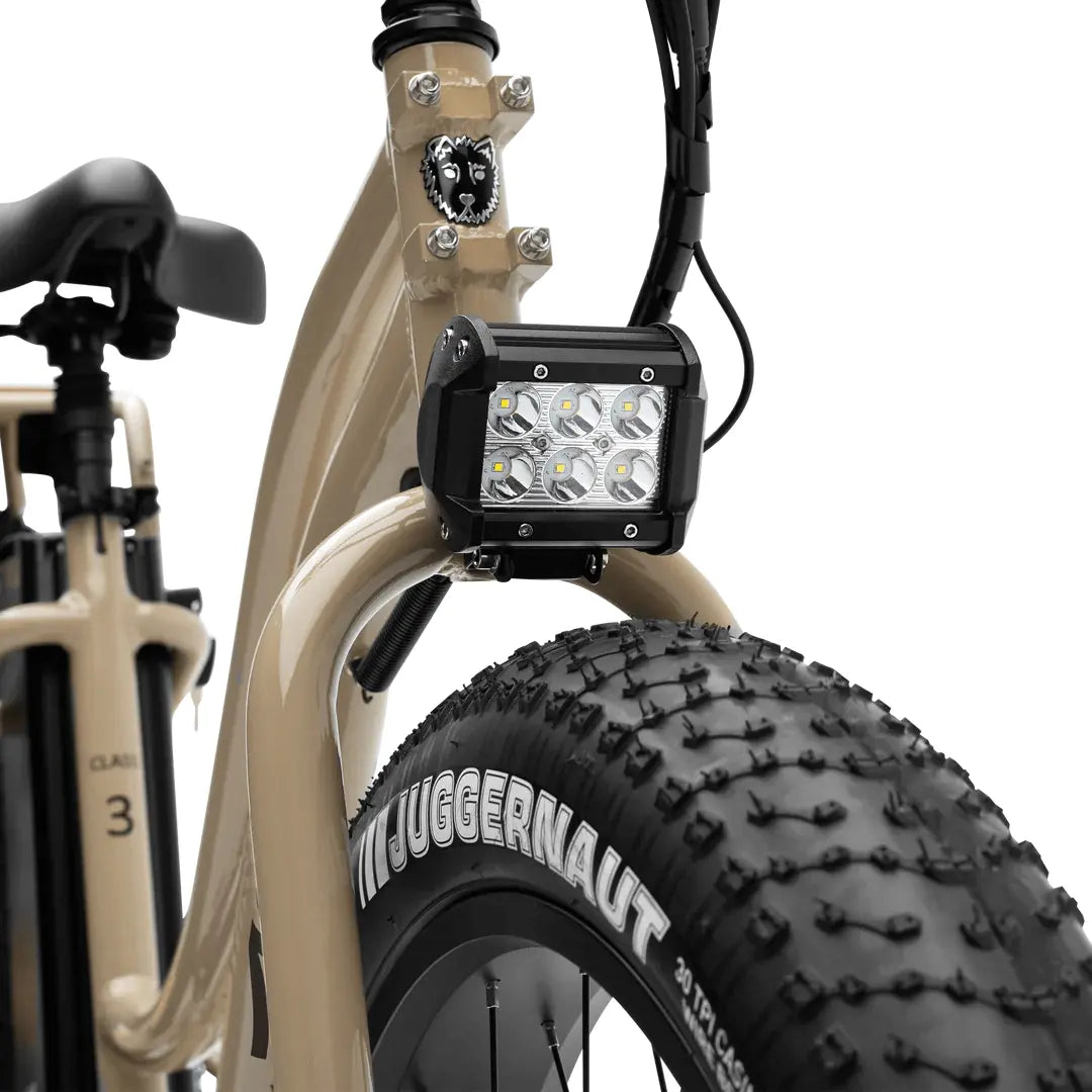 Close-up of a bike with a light attached to the frame on a white background