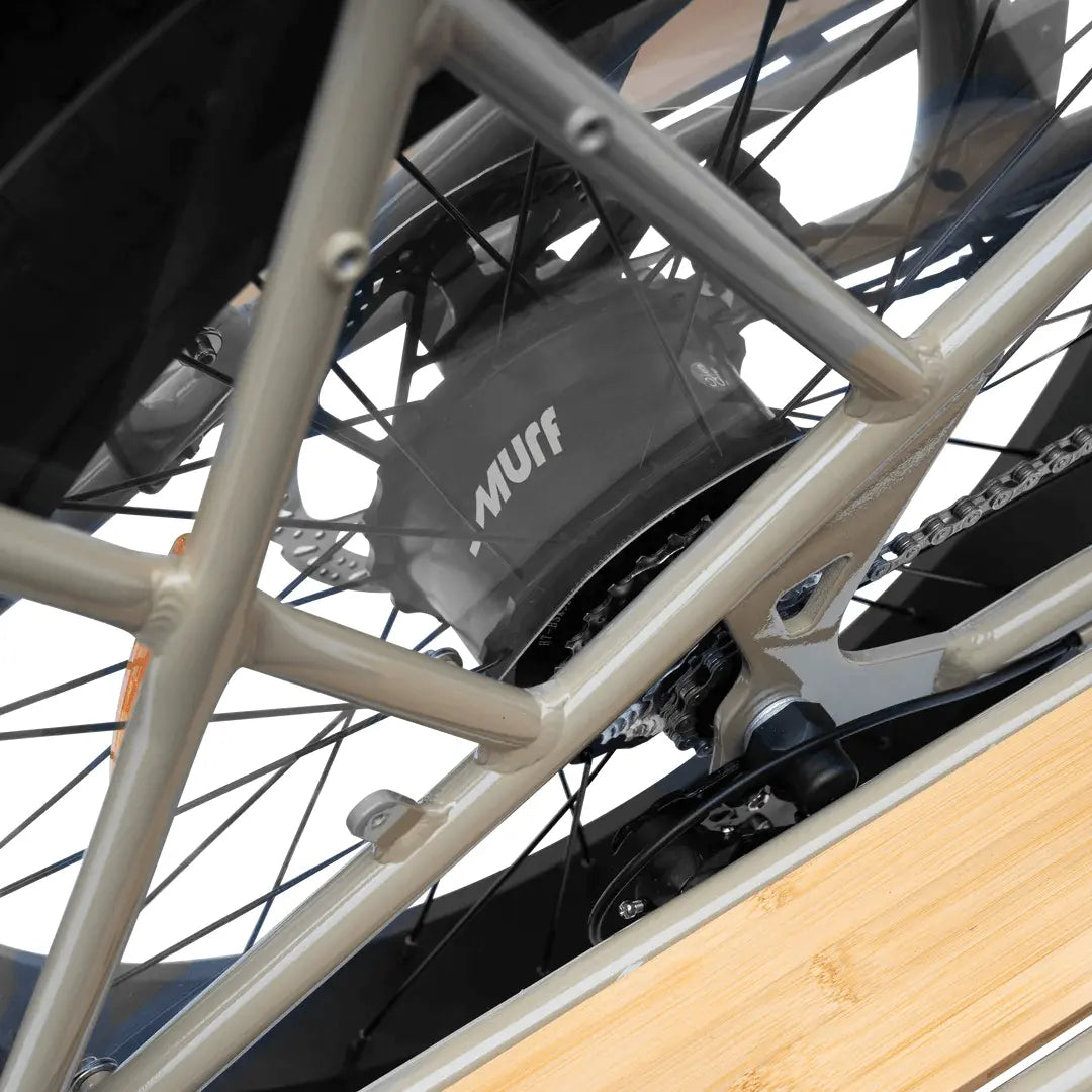 Close-up of a bicycle chain and gear system with 'Nuff' branding.